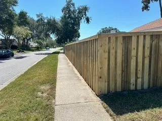 Wood privacy fence installed along a neighborhood sidewalk in Jacksonville