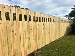 Shadowbox style wood fence running along the rear of a residential lot